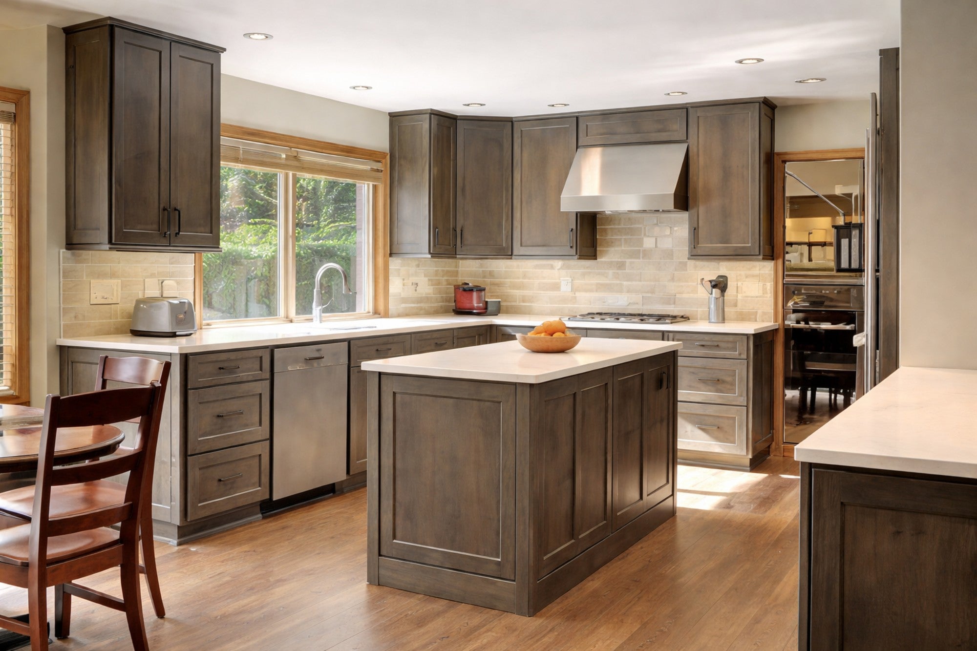 Medium wood, greige color shaker kitchen with center island, quartz countertops and stainless steel appliances